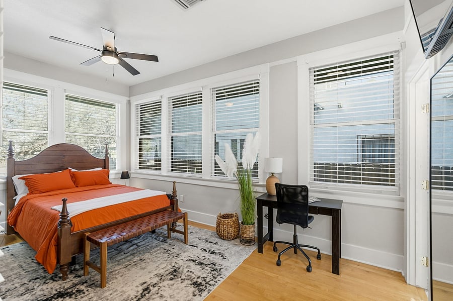 Large windows fill the suite with natural light, creating a bright and inviting space.