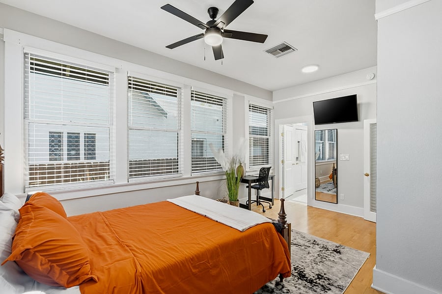 Comfortable primary suite with workspace, smart TV, and en-suite bath offering the added convenience of a private exterior entrance.