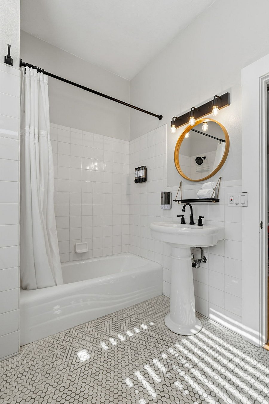 Updated bath with shower-tub combo, installed soap dispensers, starter toiletries, and plush hair wrap towels.