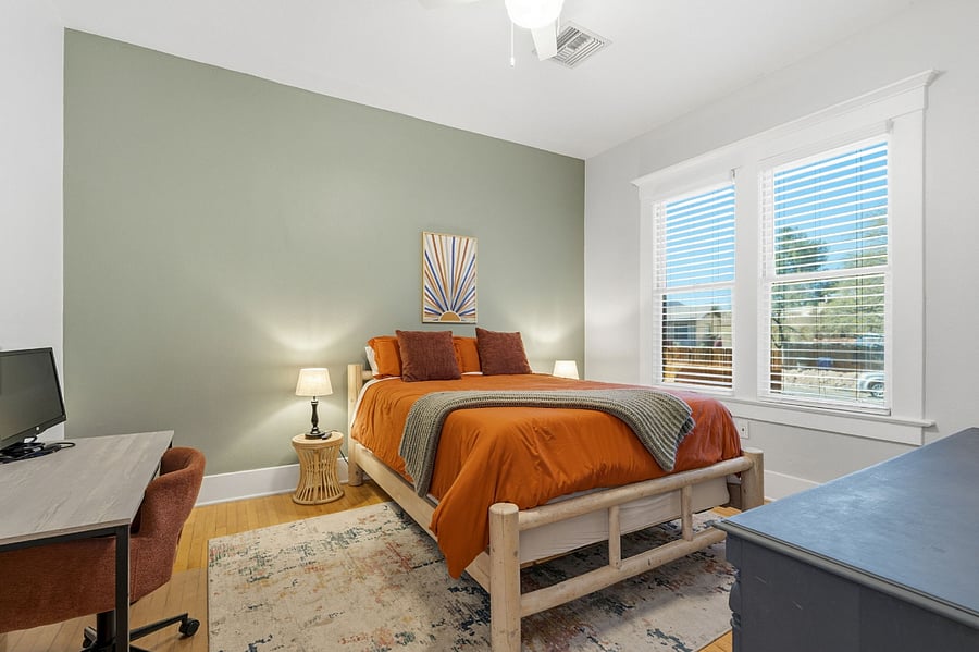 Bright, comfortable bedroom with a queen bed, large windows for plenty of natural light.