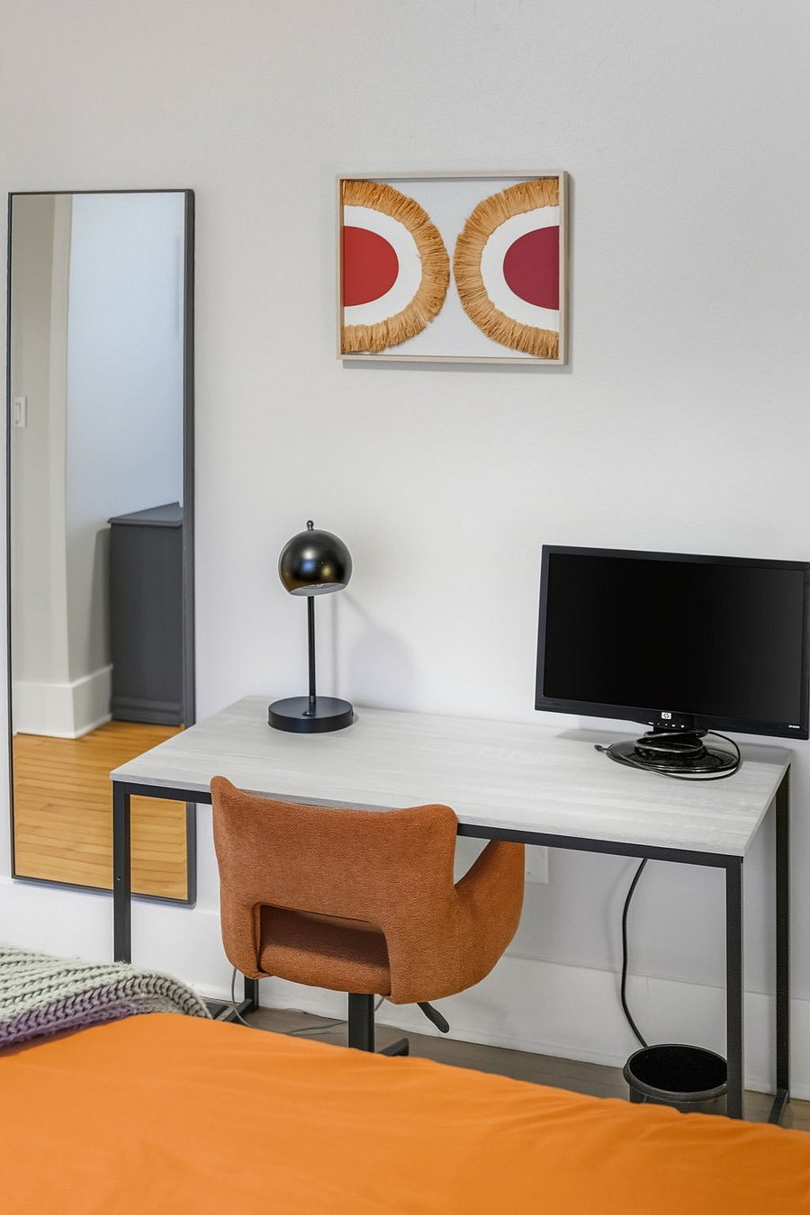 Fully set up workspace with monitor, comfortable chair, and task lightingready for productive days.