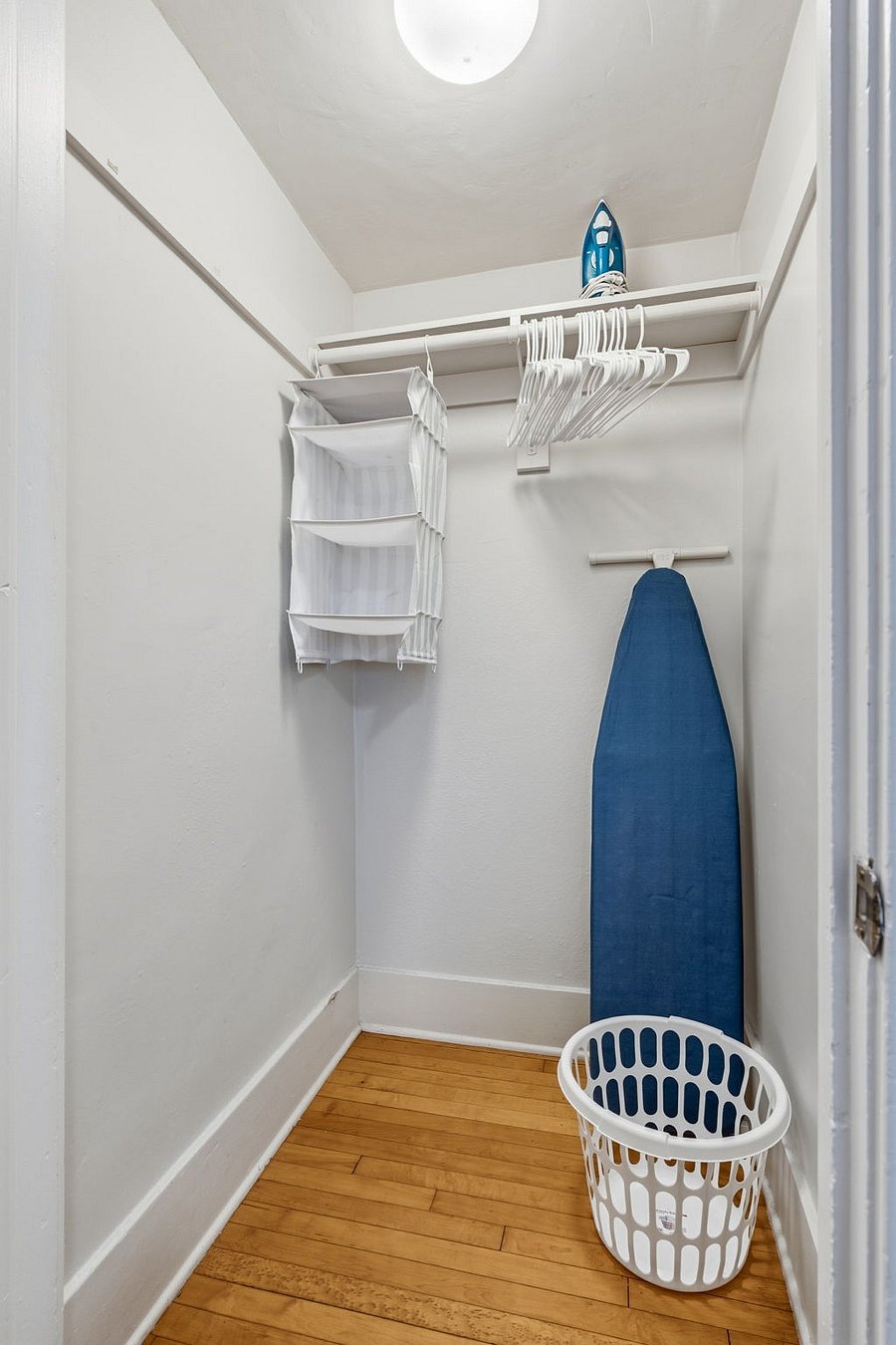 Walk-in closet with ample storage, plus iron and board
