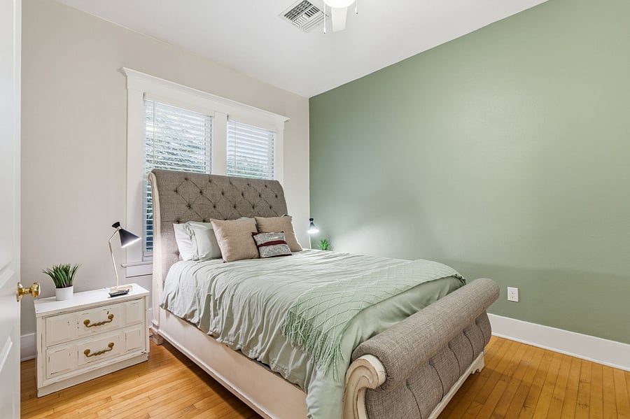 Inviting queen bedroom with adjustable base bed, premium mattress, cozy seating, ample storage, and walk-in closet.