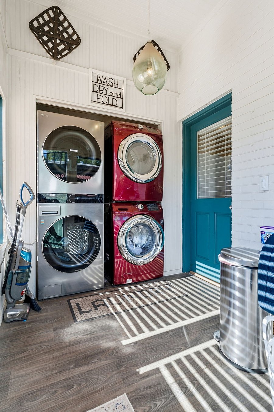 Convenient shared laundry room with two full washer/dryer sets and starter laundry supplies.