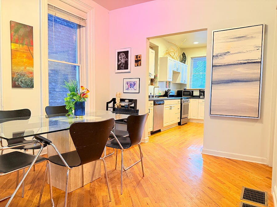Dining table with seating for 6, perfect for shared meals and conveniently located next to the fully stocked kitchen.