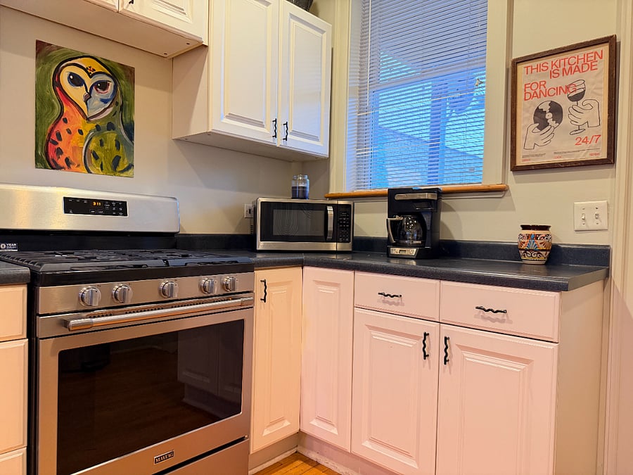 Prepare meals with ease in a fully stocked kitchen featuring cookware, dishes, utensils, a coffee maker, microwave, refrigerator, and toaster.