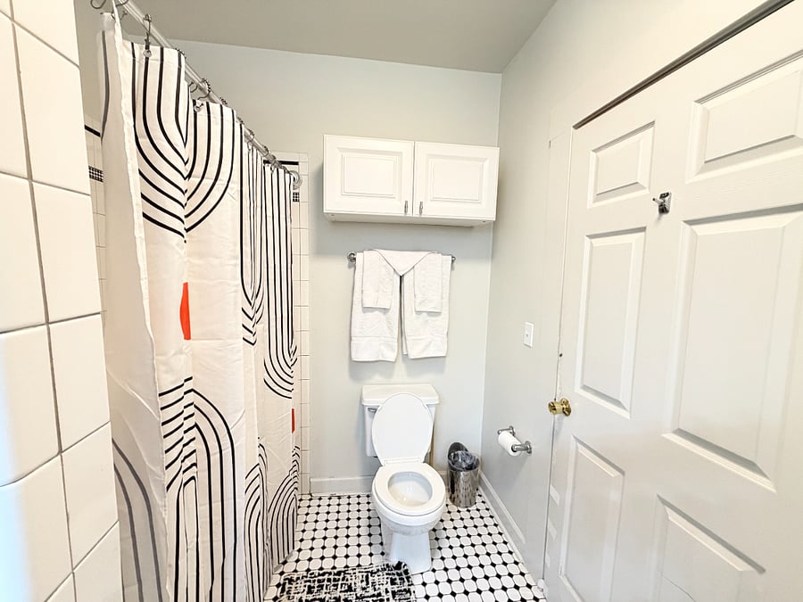 Clean and modern bathroom stocked with essential toiletries and fresh towels for your convenience.