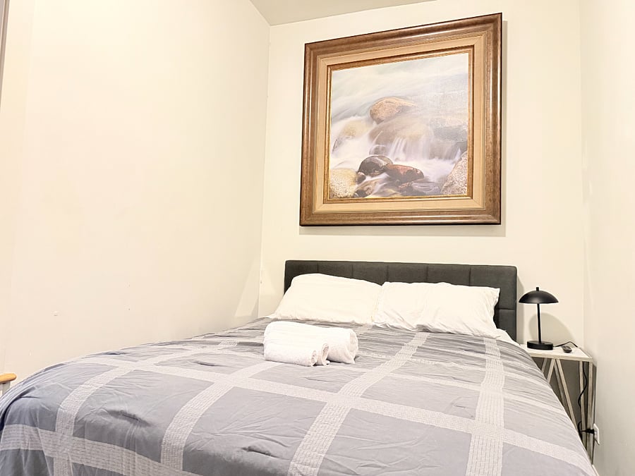 Comfortable bedroom with a double bed, soft linens, side lamp, and a peaceful atmosphere for a restful nights sleep.