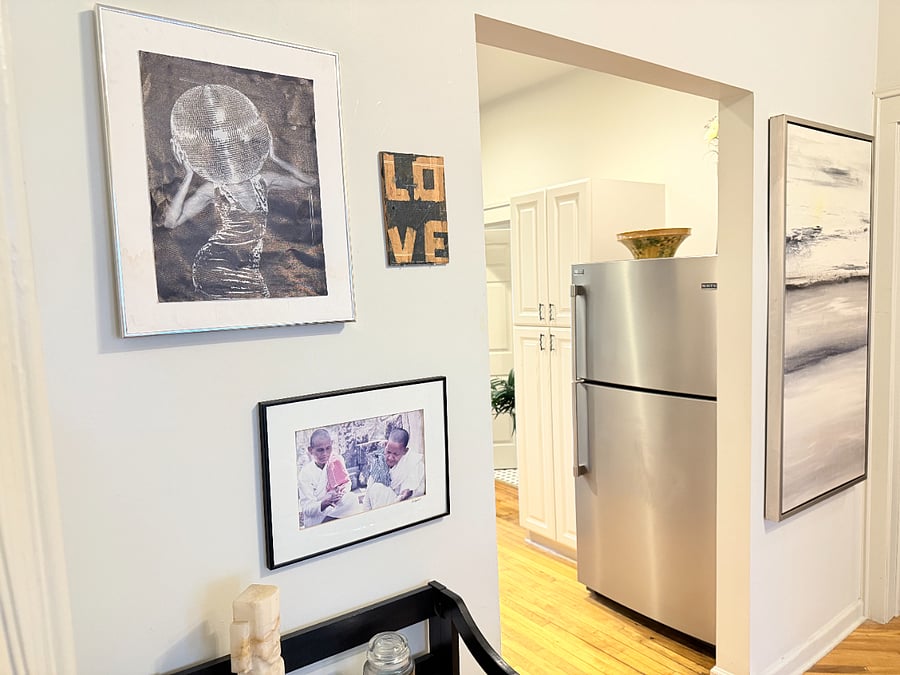 Cozy corners filled with art and character, leading right into a bright, fully equipped kitchen