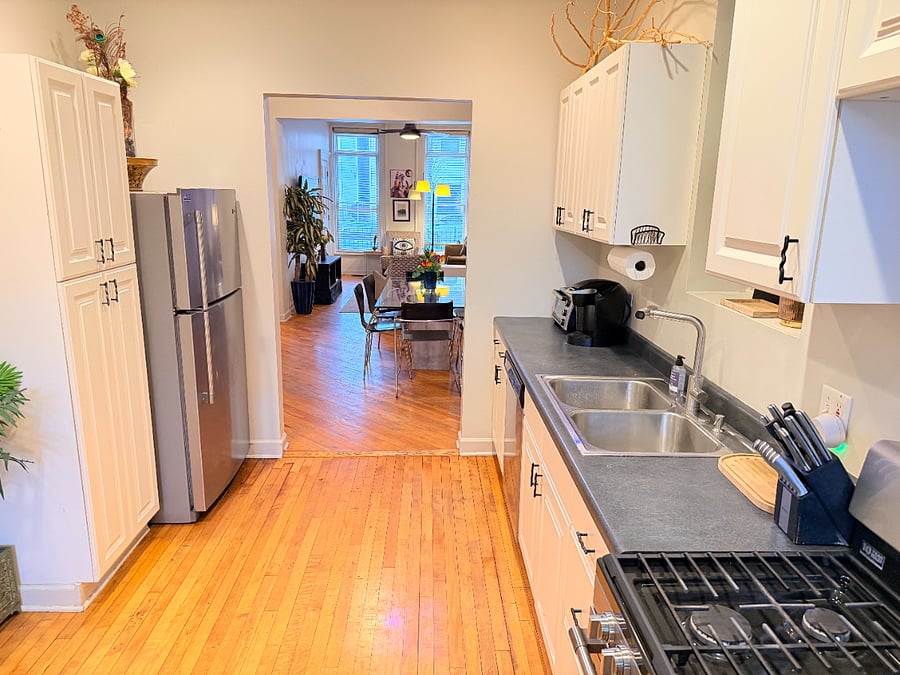 Prepare meals with ease in a fully stocked kitchen featuring cookware, dishes, utensils, a coffee maker, refrigerator, and toaster.
