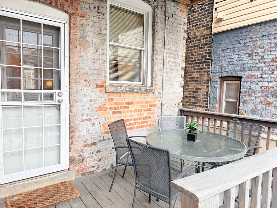 Private patio with outdoor seating, perfect for relaxing or enjoying a meal outside.