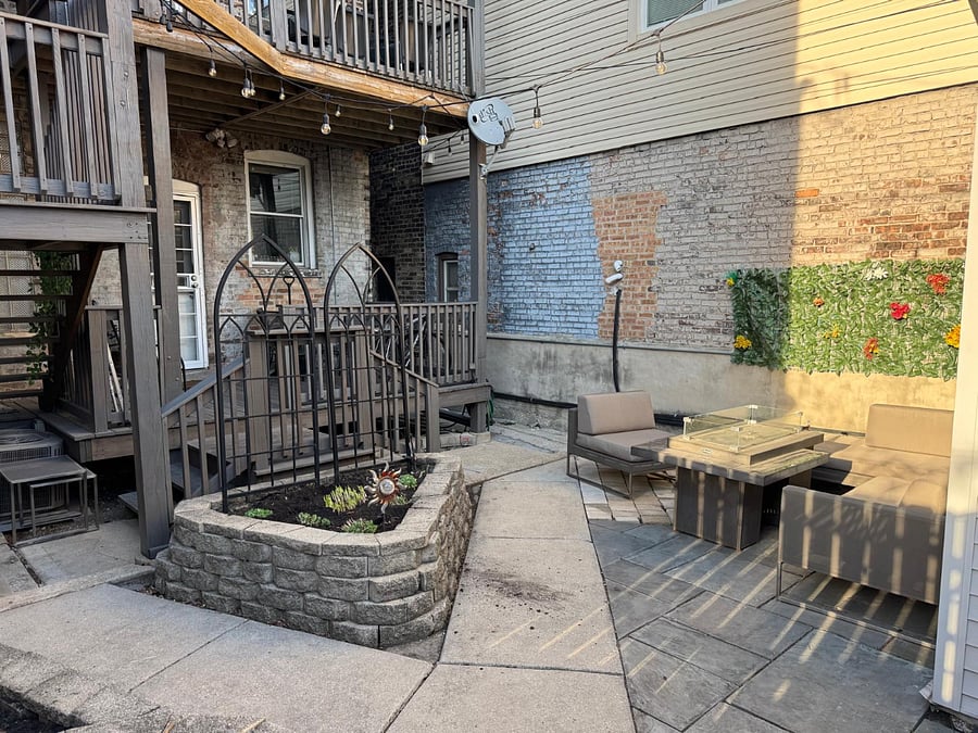 Backyard with outdoor seating, BBQ and fire pit. Perfect for relaxing or enjoying a meal outside.