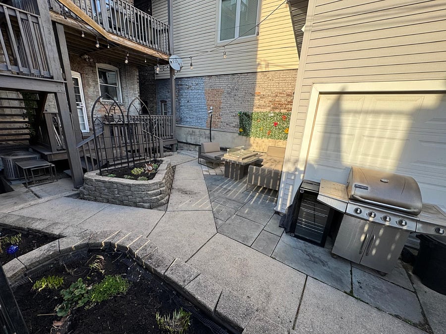 Backyard with outdoor seating, BBQ and fire pit. Perfect for relaxing or enjoying a meal outside.