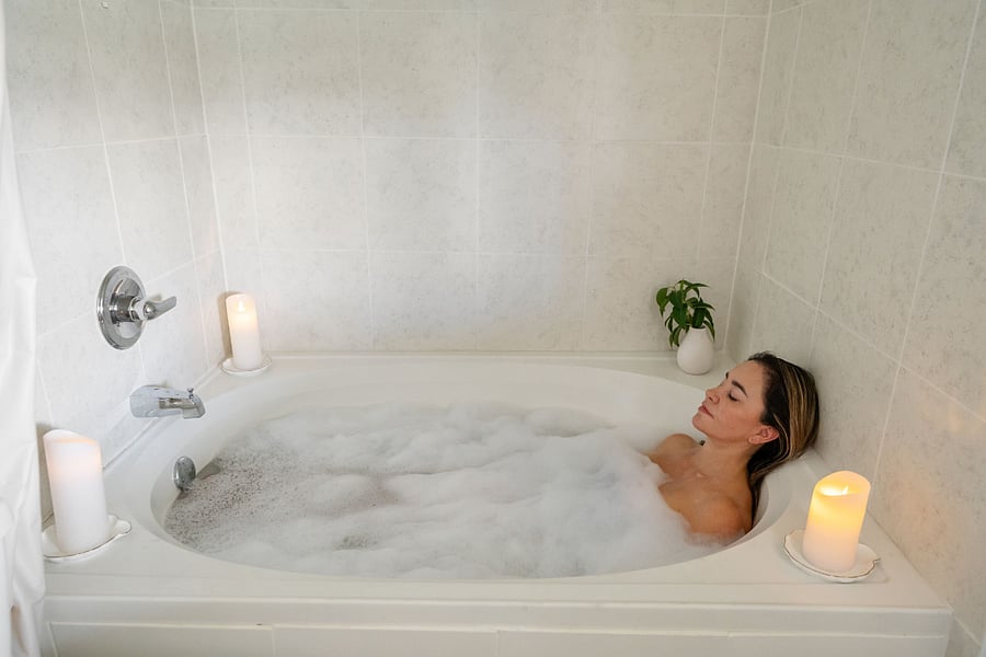 Beautifully designed bathroom, filled with natural light that creates a refreshing and airy atmosphere. Indulge in relaxation with a large bathtub and a luxurious rain shower, perfect for unwinding after a long day.