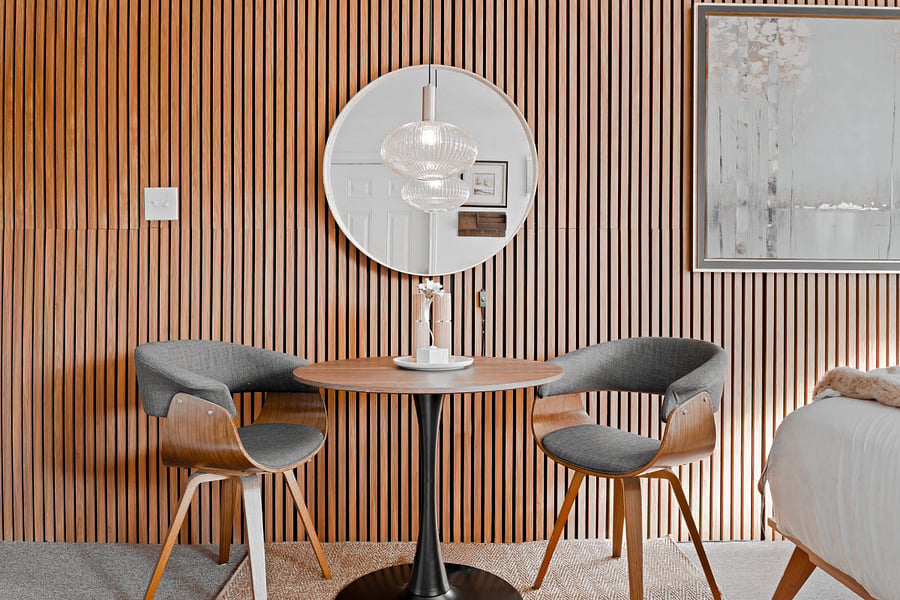 Experience comfort and versatility in our charming space, featuring a beautifully designed round table surrounded by plush, padded chairs. Whether you're enjoying a delightful meal or need a dedicated workspace, this area is perfect for both dining and productivity. The inviting ambiance creates a relaxing atmosphere, making it an ideal spot to unwind or focus on your tasks. Embrace the comfort of home during your stay!