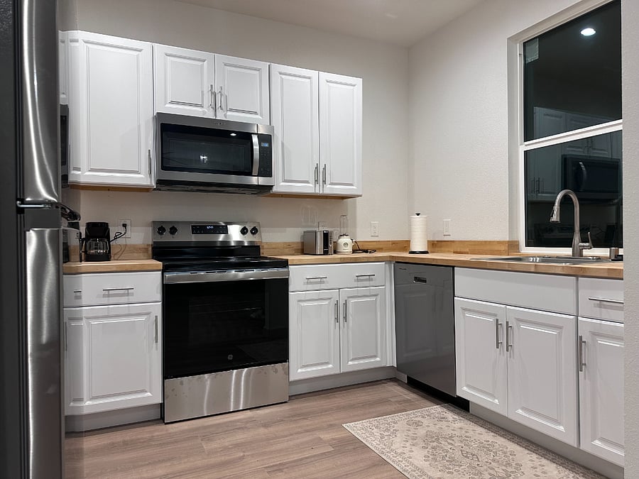 Full kitchen with large and small appliances.