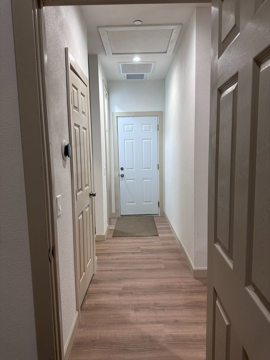 Hallway from bedroom door to garage entry