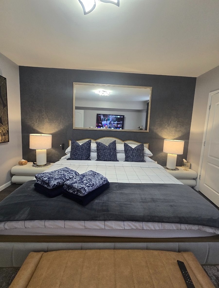 Spacious bedroom with a comfortable king-size bed, premium mattress, and a large walk-in closet for ample storage.