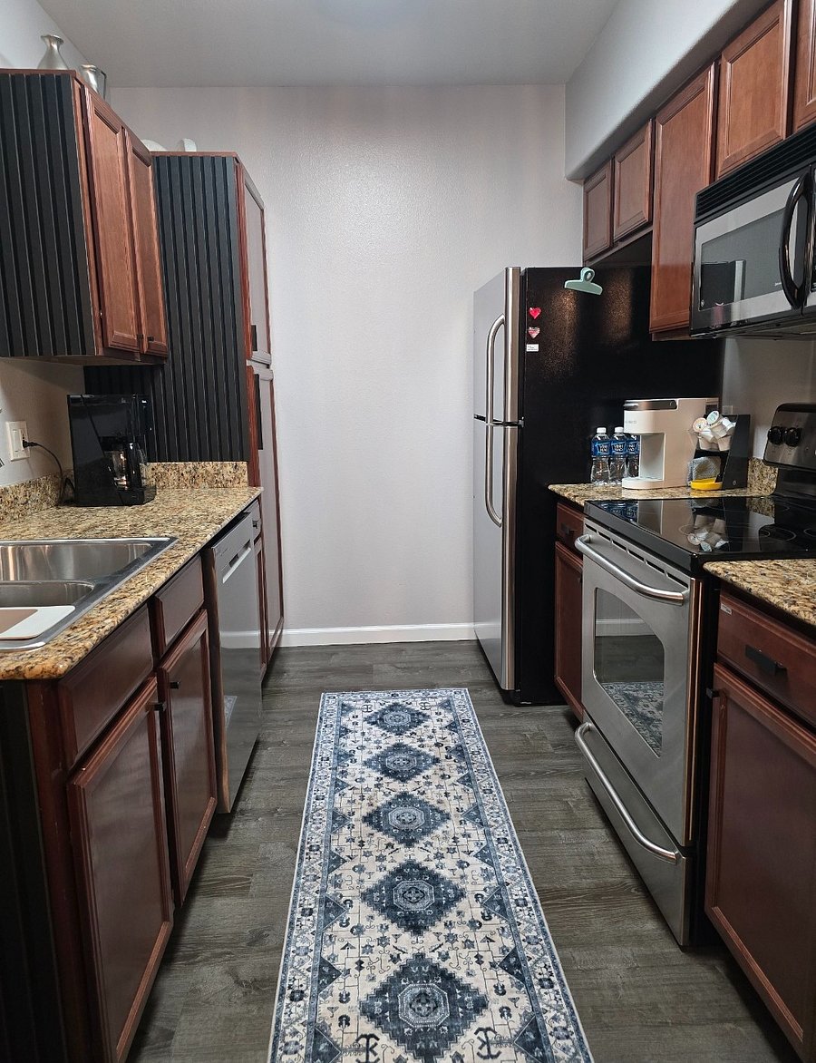 Fully stocked kitchen with all essentials, including cookware, dishes, utensils, and a coffee maker.