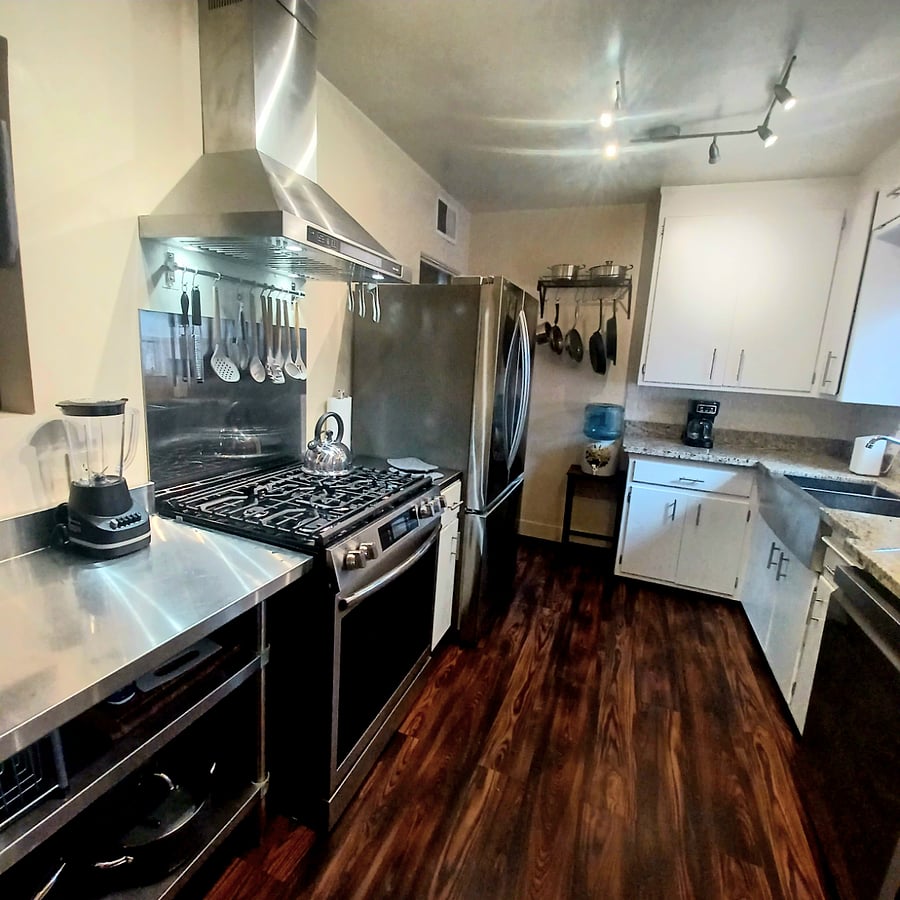 Chef's kitchen with gas range, large  fridge, dishwasher, microwave, toaster, coffee pot, blender and all cookware, dishware and glasses. 