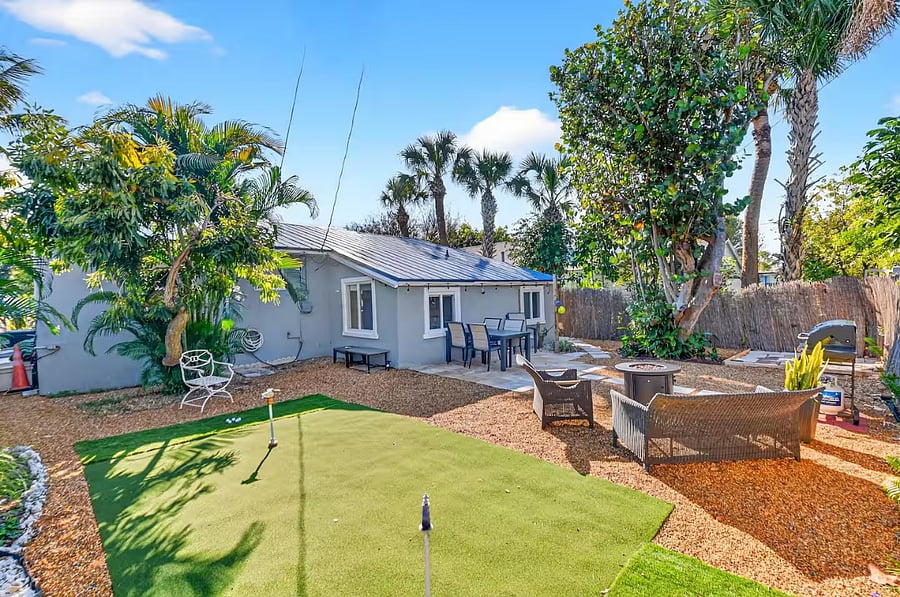 Private back yard with putting green.