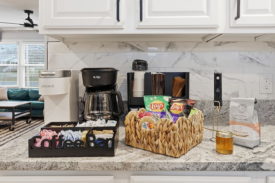 Stocked coffee and tea bar. Creamer, sugars, snacks, and treats included.