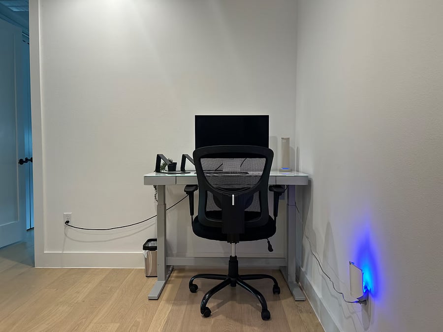 Rising desk High end work monitor Wireless keyboard Wireless mouse Wireless phone charger Office chair