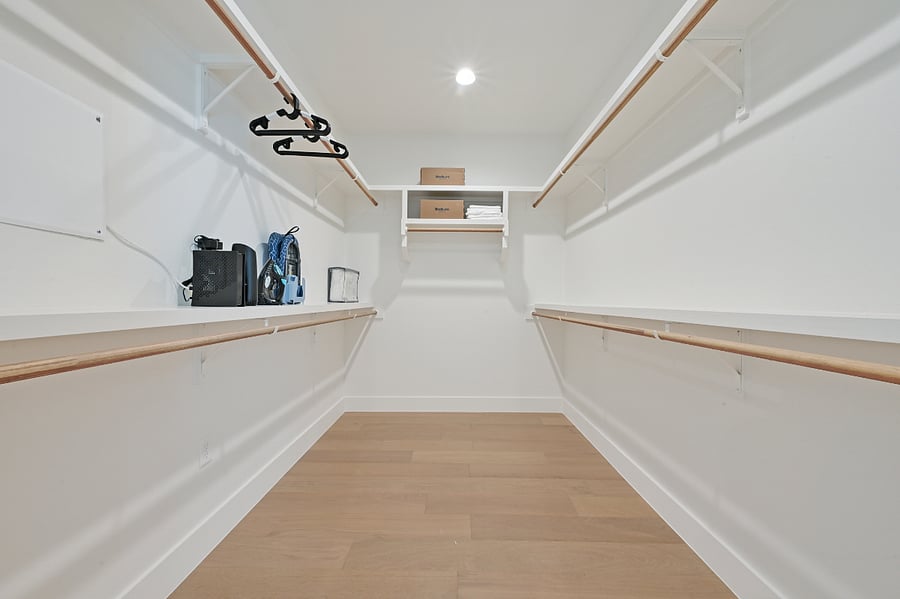 Master bedroom walk in closet Extra bedding Iron with ironing board hangers