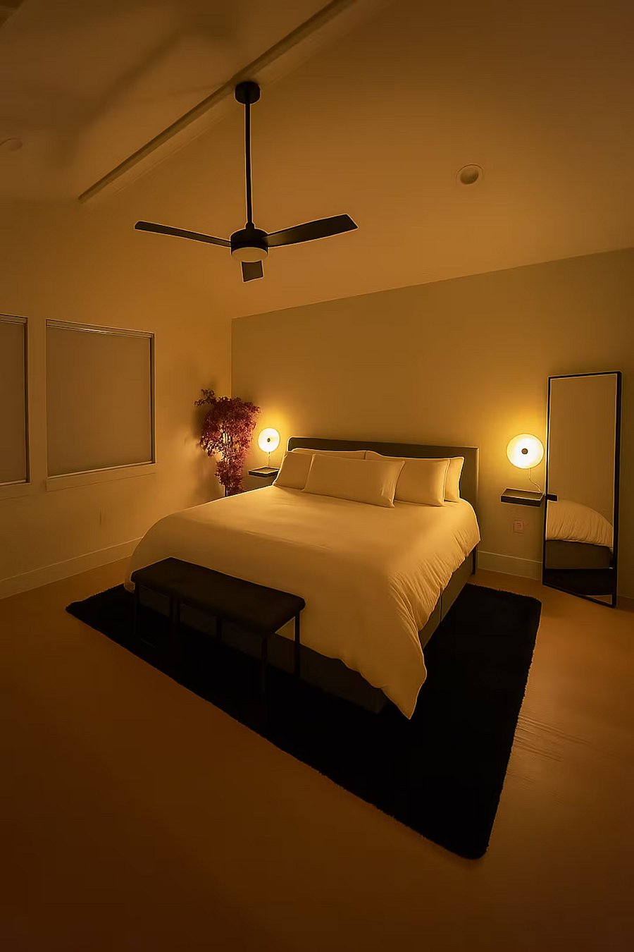 King size bed 70" TV Extra bedding Vaulted Ceilings Blackout blinds with frosted windows Extra bedding USB and USB-C Outlets Barn door to restroom Full size mirror Bedroom bench Warm lighting Bougainvillea plant