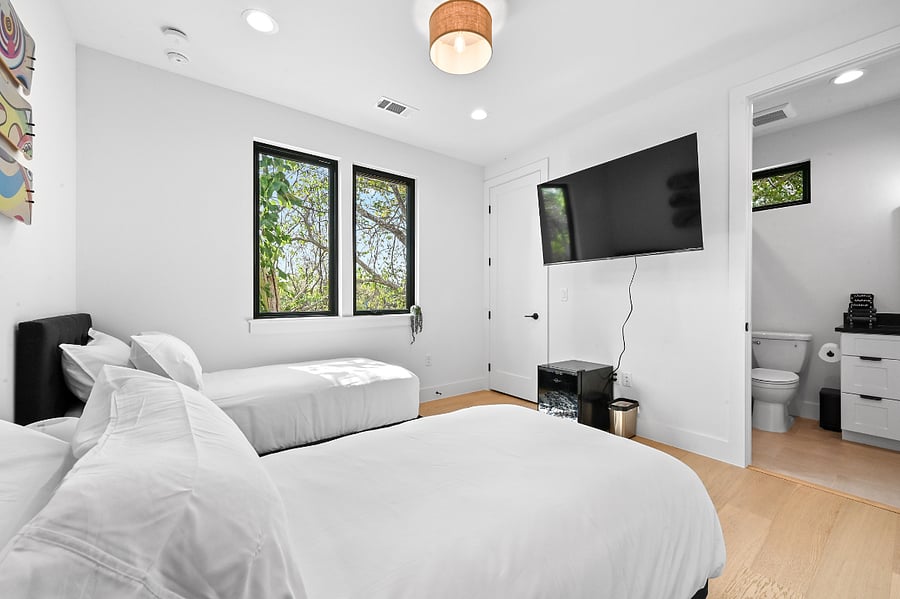 Two twin beds 65" Smart TV Mini fridge with drinks Blackout blinds USB and USB-C Outlets Olive tree