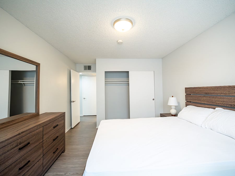 Bedroom 2 with furnishings and view of closet and bedroom door.l