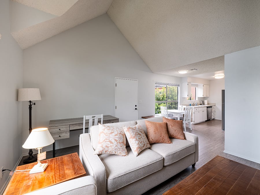 View of the living room with all furnishings, dining room, and kitchen from the FP.