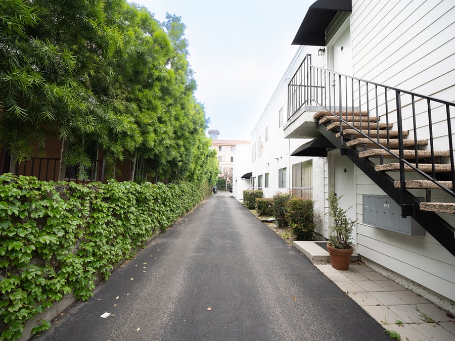 Driveway past front of 1103 W Angeleno Ave - 6 unit building to the enclosed designated tenant parking lot.