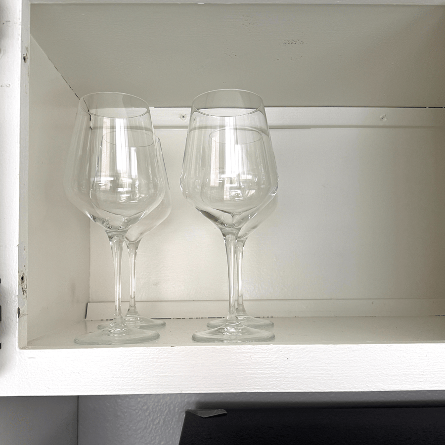 Wine glasses x 4 above the fridge