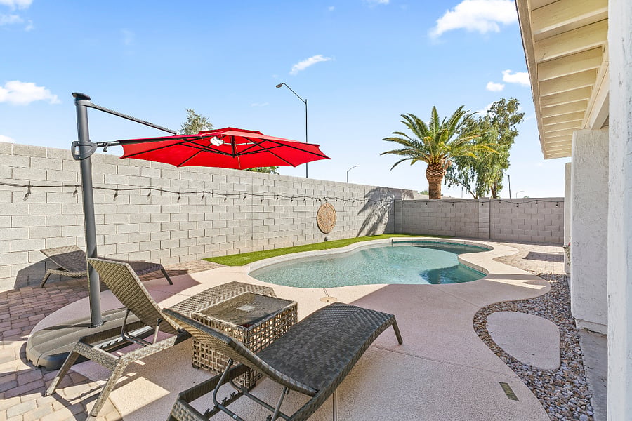 Outdoor heated pool with loungers and umbrellas