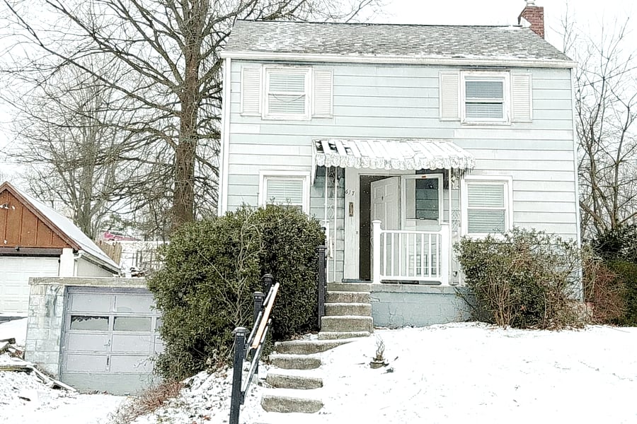Exterior view of the private single-family home with attached garage and driveway parking