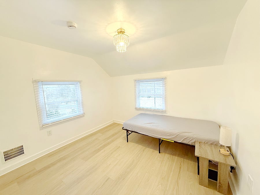 Guest bedroom with a twin bed and extra living/working space