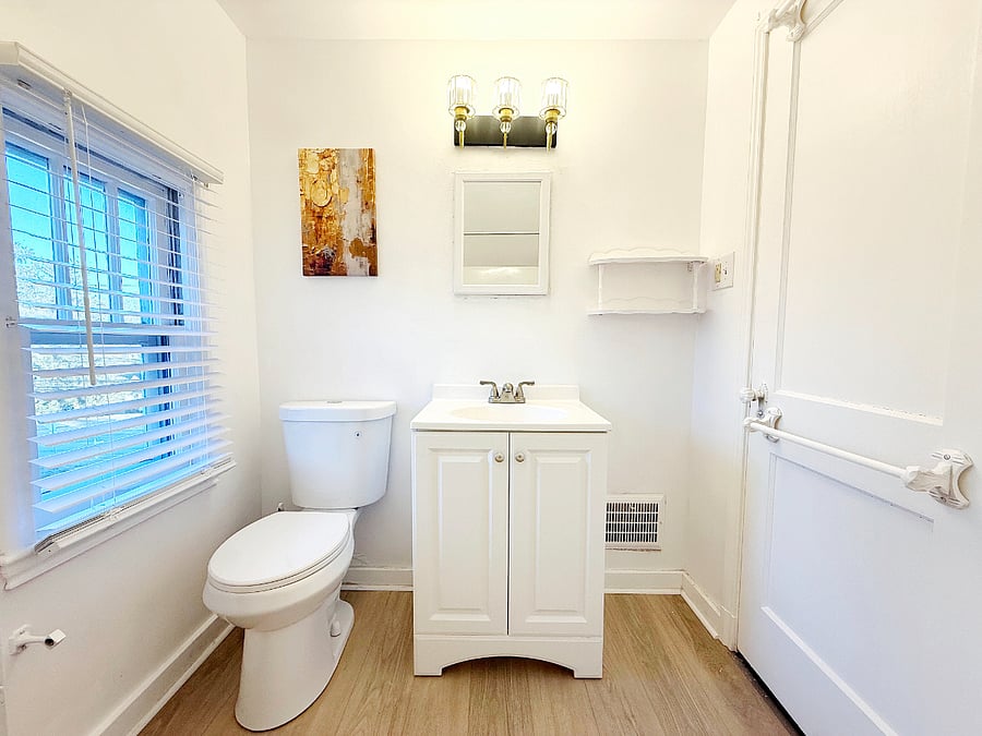 Clean and modern bathroom with updated finishes and stylish lighting
