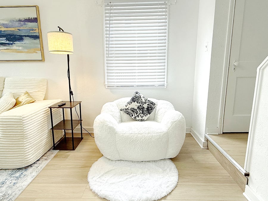 Bright, open living room with a brand new sofa set, TV and modern artwork, creating a clean and relaxing space