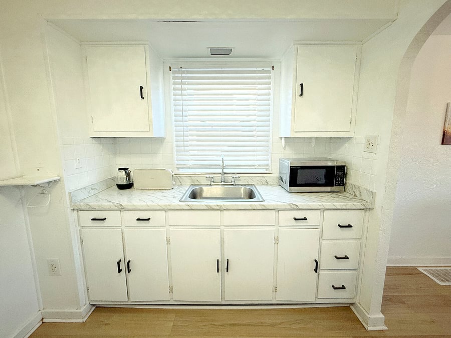 Modern kitchen with a brand new French door refrigerator, stove, microwave, toaster and ample countertop space