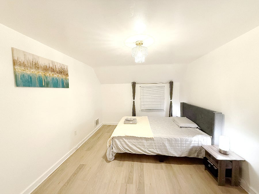 Spacious primary bedroom with a queen bed, built-in wardrobe, and a high-quality memory foam mattress