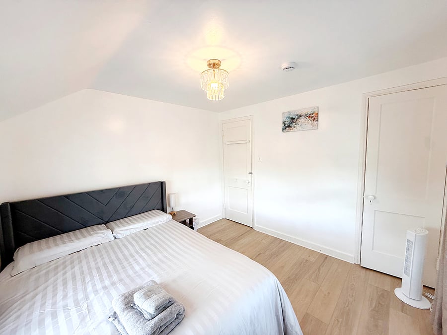 The guest bedroom also has a queen bed with a high-quality memory foam mattress and a built-in wardrobe
