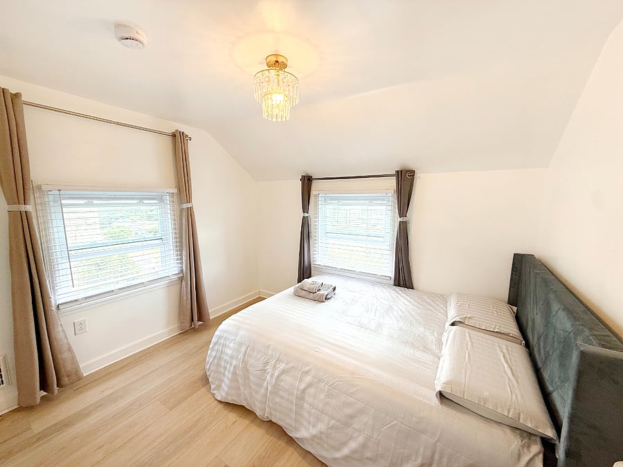 The guest bedroom also has a queen bed with a high-quality memory foam mattress and a built-in wardrobe.