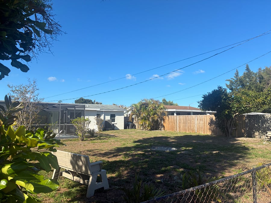 Utility drive view looking at the home shadow box fence right side with chain link on back side and removable fencing at from entry for landscapers