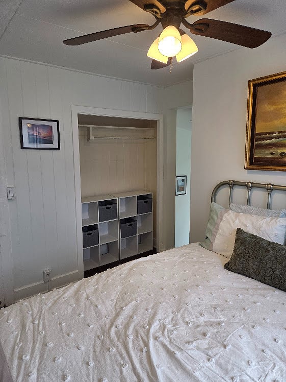 One of two closets in the bedroom, with storage shelves and baskets.