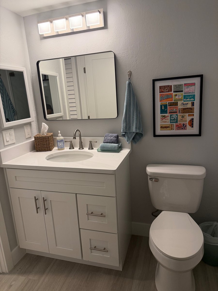 Adorable guest bath with well-lit vanity.