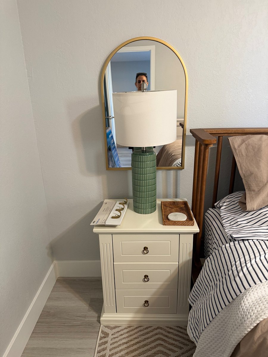 Close up of your nightstand, mirror and lamp, carefully curated to feel like a fancy boutique hotel. 
