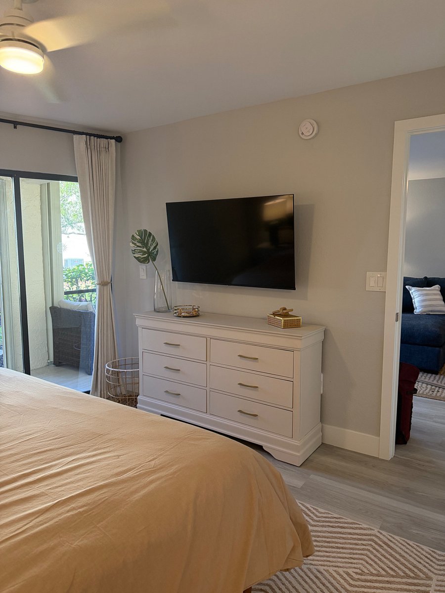 Large dresser, sliding door access to the lanai, blackout curtains, and another Smart TV!