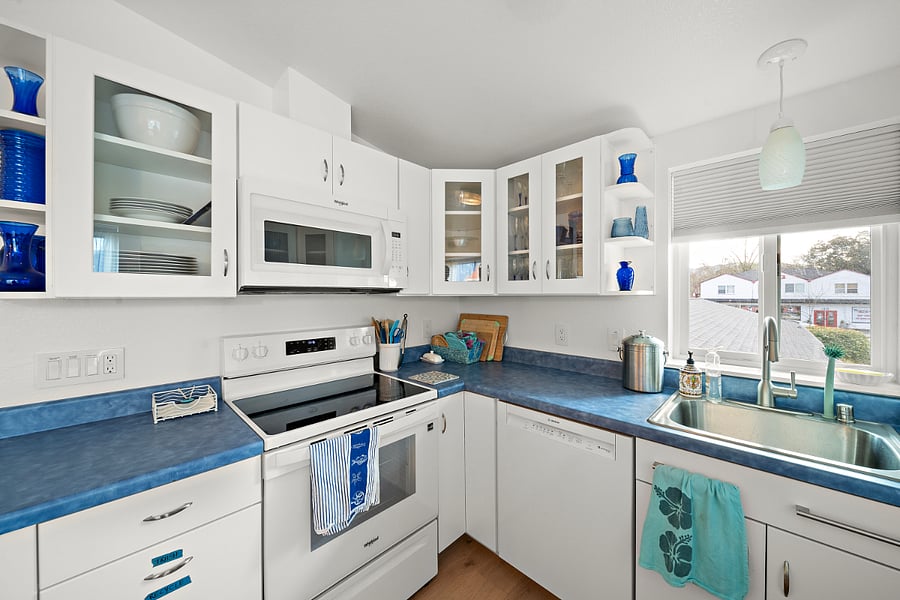 Kitchen has full sized electric range, microwave, dishwasher and refrigerator.