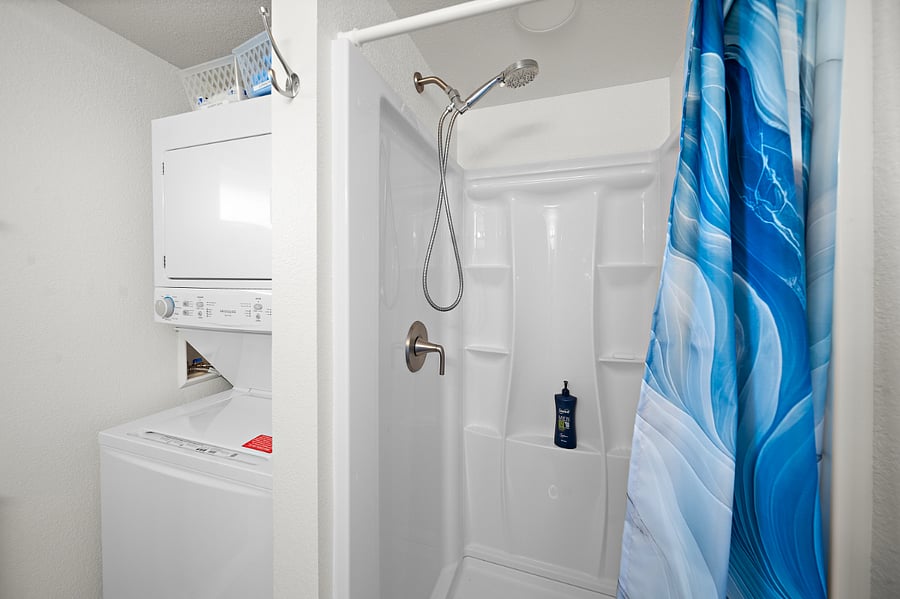 Convenient stacking washer and dryer in bathroom.